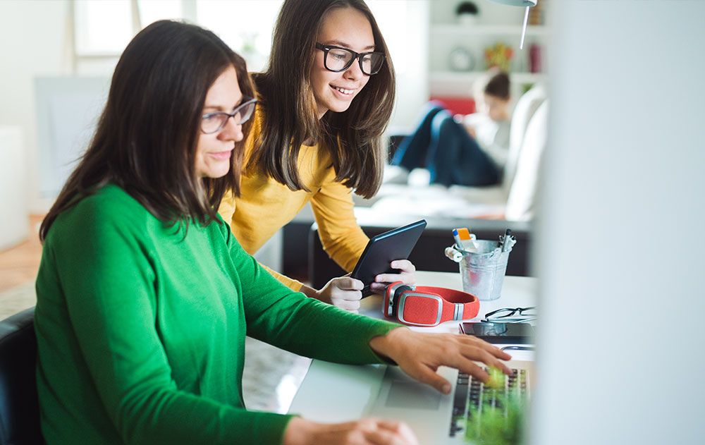 mother daughter at the computer