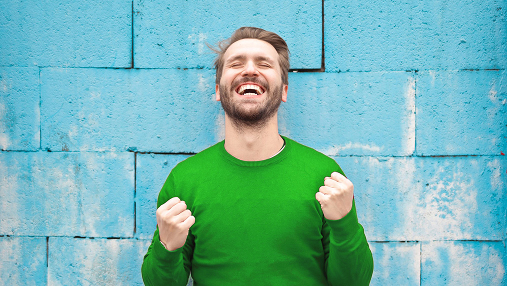 happy man in BayPort green sweater